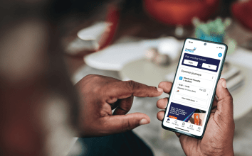 A gentleman holding a mobile device which is displaying the TPExpress app