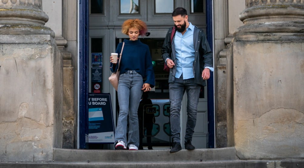 Two people leaving Huddersfield station