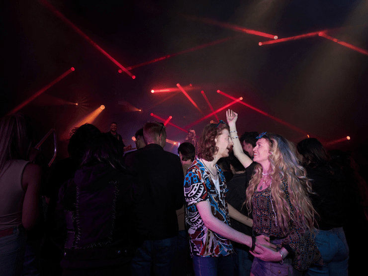 A couple at a gig with flashing lights